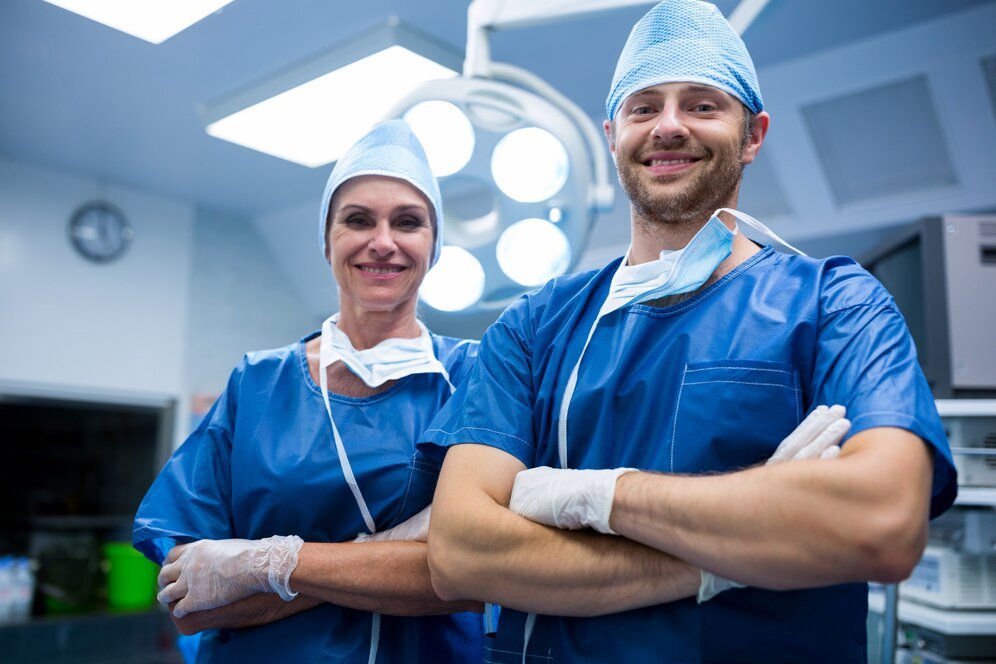 Two surgical professionals in an operating room