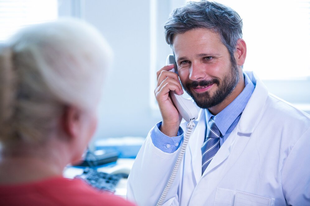Physician taking a call with a patient